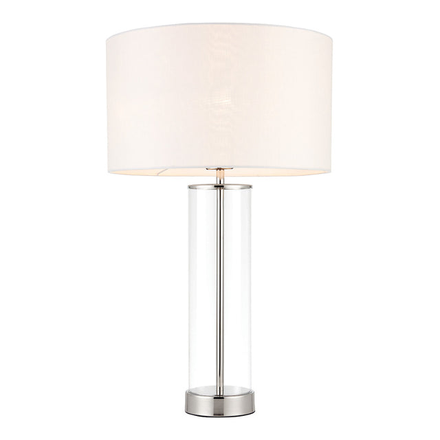 Endon Caldley table lamp with clear cylindrical glass base, bright nickel fittings and vintage white faux silk drum shade, on a plain white background.
