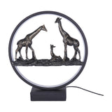 Libra Interiors LED Giraffe Family circular lighting accessory with three antique bronze resin giraffes inside a matt black LED ring on a square base.