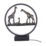 Libra Interiors LED Giraffe Family circular lighting accessory with two adult giraffes and a resting calf in antique bronze resin within a matt black LED ring.