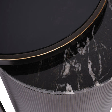 Close-up of Libra Interiors Marble Glass Nesting side table showing black tinted glass top with gilded dark bronze rim above a black veined marble drum.