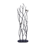 Libra Interiors Aluminium Branch and Bird Floor Sculpture in black, with tall cast branches and two antique brass birds on an oval base, plain background.
