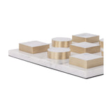 Libra Interiors marble effect white and brass noughts and crosses game with circular counters and square blocks edged in brass on a marble resin board.