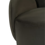 Close-up of the Libra Interiors Bingham velvet swivel accent armchair in green, showing the curved padded back, rounded arm and cushioned seat.