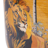 Close-up of the Libra Interiors Painted Iron Jungle Planter in gold, showing a detailed lion motif with tropical foliage in blue, gold and yellow.