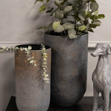 Libra Interiors Textured Iron Cylinder Planters in blue-grey with gold flecks, styled with eucalyptus stems beside a silver greyhound figurine in a hallway.