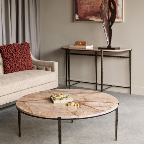 Libra Interiors Marble Round Coffee Table with brown veined marble top and hammered bronze iron legs, styled in a living room with cream sofa.