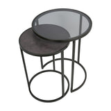 Libra Interiors Slate Effect Iron Nesting Side Tables in black, round set with tinted glass top and slate-effect surface on slim iron frames.