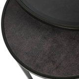 Close-up of Libra Interiors Slate Effect Iron Nesting Side Table in black, showing the tinted glass top overlapping the textured slate-effect lower surface.