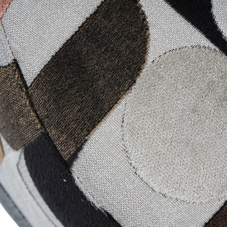 Close-up of Libra Interiors Patterned Velvet Swivel Armchair showing slub velvet upholstery with geometric patches in cream, espresso, black and blush tones.