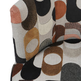 Close-up of Libra Interiors Patterned Velvet Swivel Armchair showing retro geometric circles in blush, ochre, espresso and black on neutral velvet.