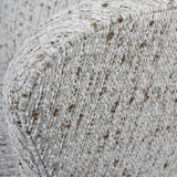 Close-up of Libra Interiors Textured Swivel Fabric Armchair in Natural, showing the ivory, sand and almond flecked slub weave over a rounded padded frame.