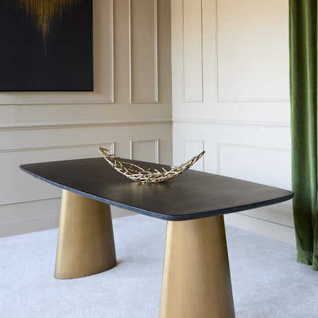 Libra Interiors Black Marble & Brass Twin-Pedestal Dining Table with softened rectangular top on two brass cone bases, styled with a gilt twig bowl.