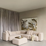 Libra Interiors Chenille 5-Piece Modular Sofa in natural beige with matching ottoman, arranged in a neutral living room with tropical wall art and curtains.