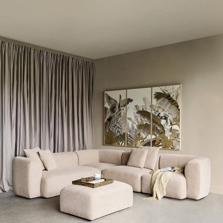 Libra Interiors Chenille 5-Piece Modular Sofa in natural beige with matching ottoman, arranged in a neutral living room with tropical wall art and curtains.