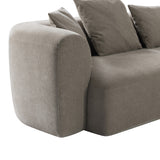 Close-up of the Libra Interiors Chenille 5-Piece Modular Sofa in natural beige, showing the rounded armrest, soft chenille upholstery and scatter cushions.