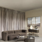 Libra Interiors Velvet Curved 2-Seater Modular Sofa in brown, styled in a living room with floor-length drapes, round coffee tables and a fluted console.