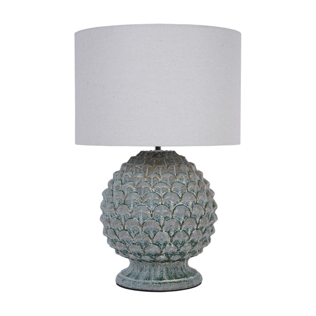 Libra Interiors Glazed Ceramic Artichoke Table Lamp in green with layered petal-textured base and neutral drum shade on a white background.