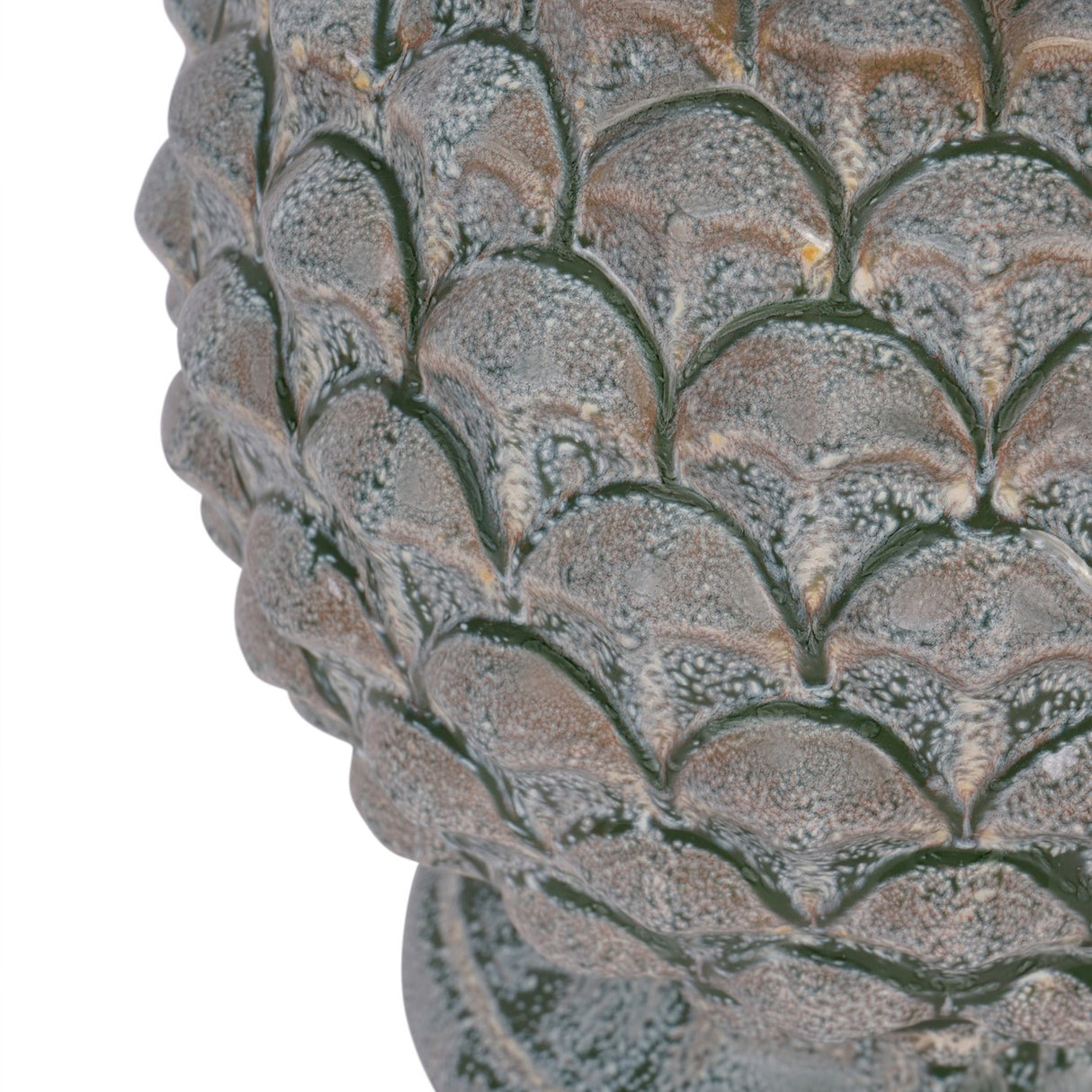 Close-up of the Libra Interiors Glazed Ceramic Artichoke Table Lamp base showing layered petal scales in a mottled green glaze with earthy tones.
