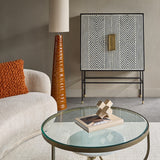 Libra Interiors Ribbed Ceramic Tapered Floor Lamp in terracotta with tall linen shade, styled beside a bouclé sofa, glass coffee table and patterned cabinet.