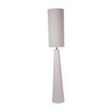 Libra Interiors Ribbed Ceramic Tall Floor Lamp in white with tapered horizontally banded base and long cylindrical neutral fabric shade on a white background.