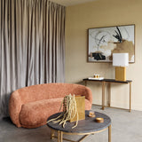 Libra Interiors Ridged Ceramic Rectangular Table Lamp in brown with cream shade on a console table beside abstract art, styled with a curved terracotta sofa.