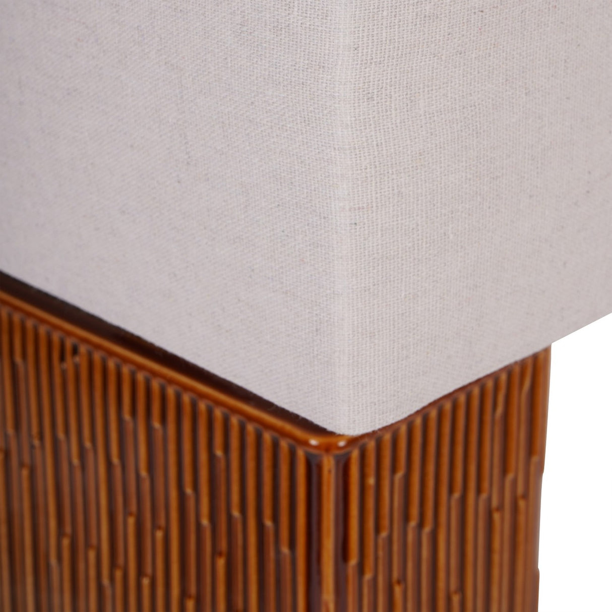 Close-up of the Libra Interiors Ridged Ceramic Rectangular Table Lamp showing the terracotta brown ridged base meeting the cream linen-look shade.