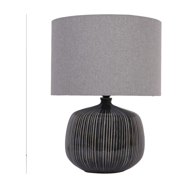Libra Interiors Ribbed Ceramic Table Lamp in charcoal with a rounded vertically ribbed glazed base and grey fabric drum shade on a white background.
