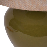 Close-up of the Libra Interiors Glazed Ceramic Hessian Table Lamp showing the rounded mossy green glazed base and woven natural hessian shade edge.