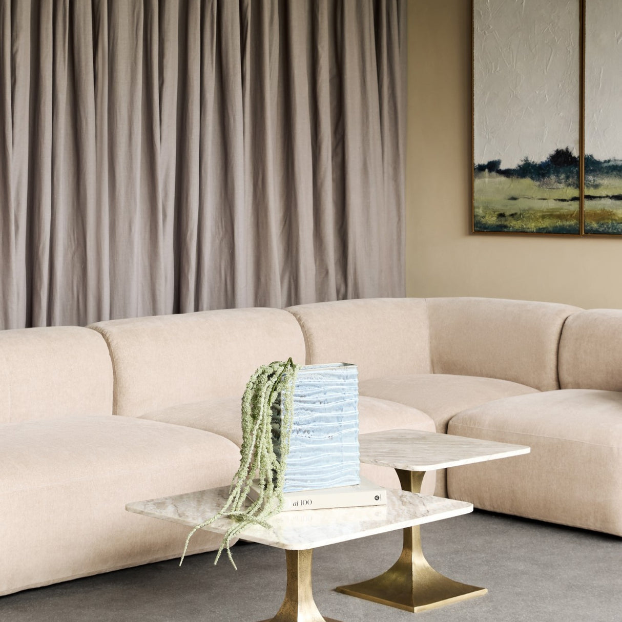 Libra Interiors Rippled Ceramic Rectangular Vase in blue with trailing faux amaranthus, styled on marble and brass side tables beside a neutral sofa.