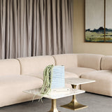 Libra Interiors Rippled Ceramic Rectangular Vase in blue with trailing faux amaranthus, styled on marble and brass side tables beside a neutral sofa.