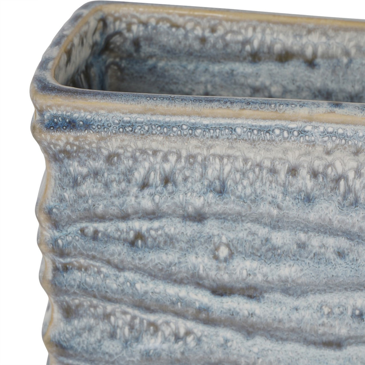 Close-up of the Libra Interiors Rippled Ceramic Rectangular Vase in blue, showing the textured reactive glaze pooling in blue, grey and white tones.