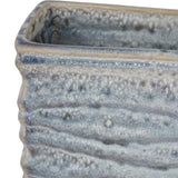 Close-up of the Libra Interiors Rippled Ceramic Rectangular Vase in blue, showing the textured reactive glaze pooling in blue, grey and white tones.