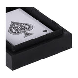 Close-up of the Libra Interiors Ace of Spades black resin card box, showing the lacquered corner and an ace of spades playing card inside.