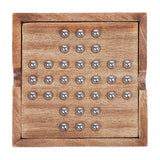 Libra Interiors mango wood solitaire board with brass-topped pegs arranged in a cross pattern, shown from above on a plain background.