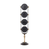 Libra Interiors Brushed Brass Four-Dial World City Floor Clock shown from the back with four circular black panels on a slim frame and pedestal base.