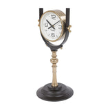 Libra Interiors brushed brass floor clock dial showing the Sydney time zone, framed in a gold surround on a sculpted pedestal with black base.