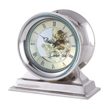 Libra Interiors Skeleton polished nickel mantel clock with exposed cogs, cream Roman numeral dial and domed glass on a stepped aluminium base.