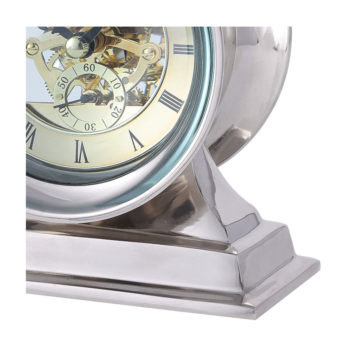 Libra Interiors Skeleton mantel clock close-up showing exposed brass cogs, cream Roman numeral dial and polished nickel case on a stepped aluminium base.