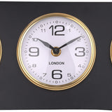 Close-up of the London dial on the Libra Interiors Matt Black Three Dial Mantel Clock, showing a white face with black numerals inside a gold bezel.