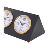 Libra Interiors Matt Black Three Dial Mantel Clock close-up showing the New York dial with gold bezel, white face and black numerals on the steel frame.