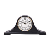 Libra Interiors Matt Black Roman Numeral Mantel Clock with humped aluminium body, white Roman numeral dial and antique gold bezel on a white background.