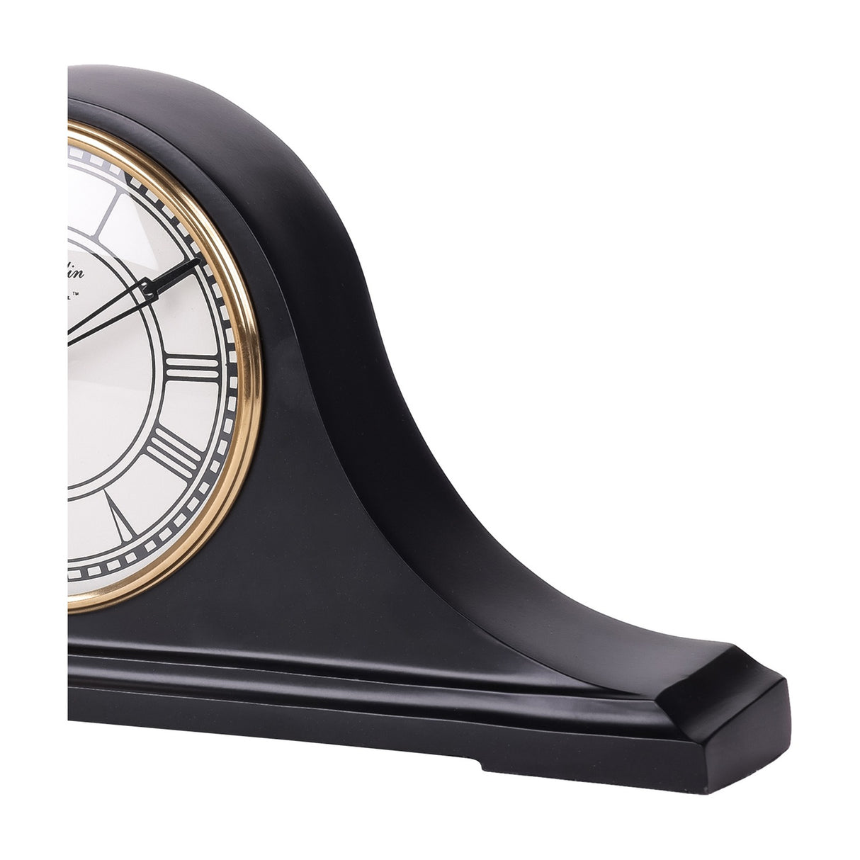 Close-up side view of the Libra Interiors matt black Roman numeral mantel clock, showing its curved humped profile, stepped base and gold bezel edge.