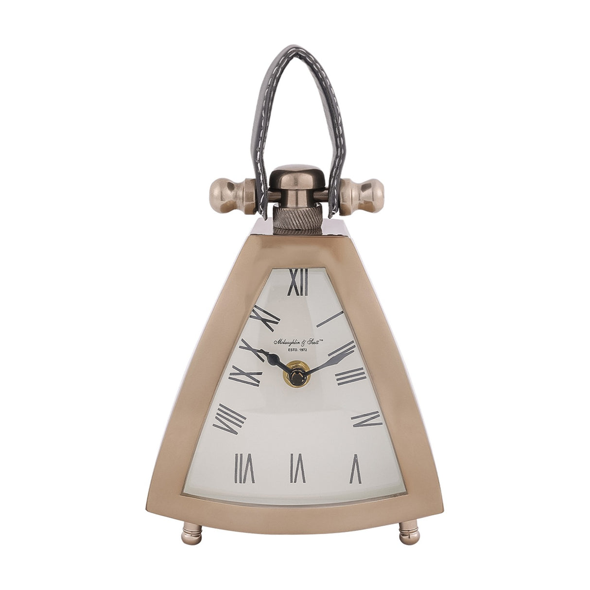 Libra Interiors brushed brass mantel clock with curved triangular case, white Roman numeral dial, leather handle and rounded feet on white.