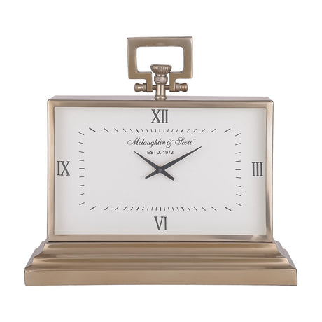 Libra Interiors brushed brass rectangular mantel clock with white Roman numeral dial, loop handle, knurled crown and stepped plinth on a white background.