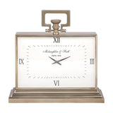 Libra Interiors brushed brass rectangular mantel clock with white Roman numeral dial, looped handle, fluted knob and stepped plinth base on a white background.