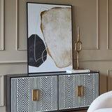 Libra Interiors Bone Inlay Four Door Sideboard in monochrome with black and white geometric inlay and brass handles, styled with abstract art and sculpture.