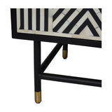 Close-up of Libra Interiors Bone Inlay Four Door Sideboard in monochrome, showing black frame corner, geometric bone inlay pattern and brass-capped legs.