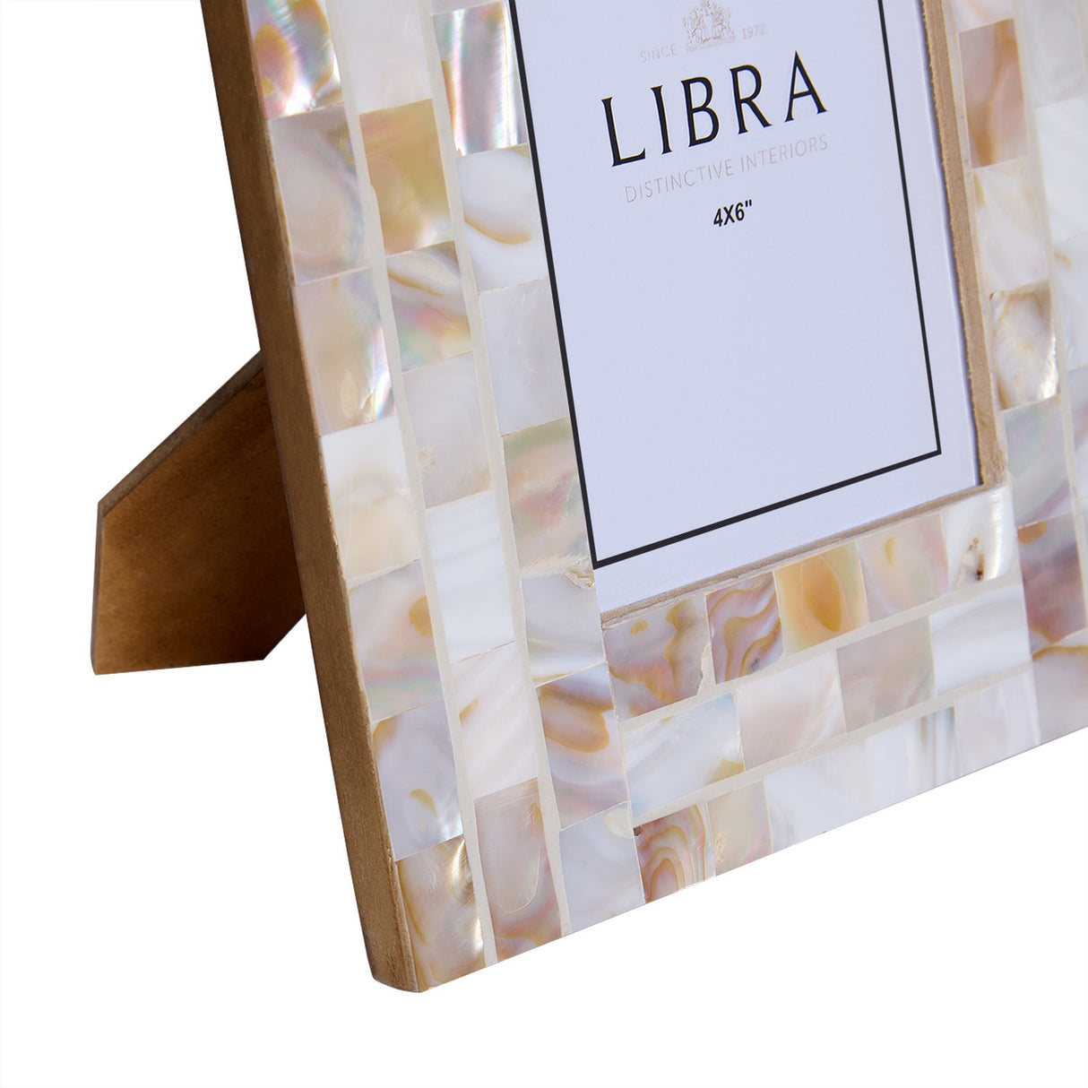 Close-up of Libra Interiors Mother of Pearl Mosaic Photo Frame 4x6 in ivory, showing shell tile border and wooden easel back on a white background.