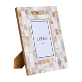 Libra Interiors Mother of Pearl Mosaic 4x6 photo frame in ivory, shown at an angle with easel stand on a white background.