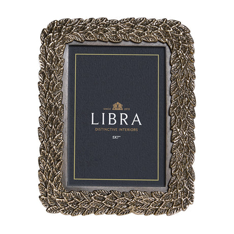 Libra Interiors antiqued gold photo frame with raised layered leaf motif border around a portrait aperture, shown on a plain white background.